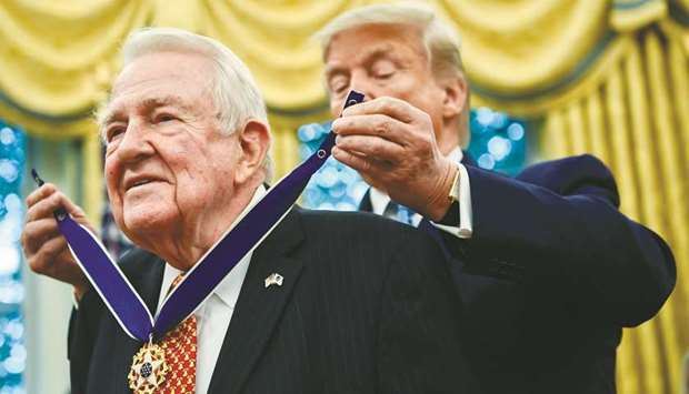 US President Donald Trump awards former attorney general Edwin Meese with the Medal of Freedom during a ceremony in the Oval Office at the White House in Washington, DC on Tuesday night.