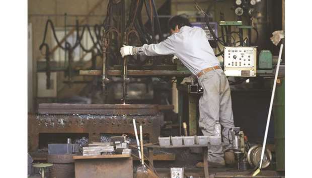 A man works around a metal procession machine at a factory in Urayasu, east of Tokyo. Japanu2019s core machinery orders, a highly volatile data series regarded as an indicator of capital spending in the coming six to nine months, fell 2.4% in August from the previous month, Cabinet Office data showed yesterday.