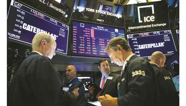 Traders work on the floor of the New York Stock Exchange (file). Calmer American shares have reached the priciest in 41 years compared with capricious counterparts, according to a Citigroup Inc study into the low-beta factor. Citi is among those firms warning that stocks offering muted price swings look too hot for comfort.