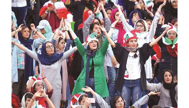 Iranian women cheer during the World Cup Qatar 2022 Group u2018Cu2019 qualification match between Iran and Cambodia at the Azadi stadium in the capital Tehran yesterday. (AFP)