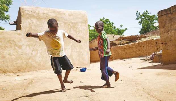 Two displaced children play in the courtyard of a house in Segou.