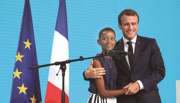 Macron welcomes an attendee in Lyon, central eastern France, yesterday on the second day of the conference of Global Fund to Fight HIV, Tuberculosis and Malaria.