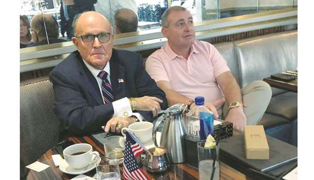 This picture taken on September 20 shows Giuliani having coffee with Ukrainian-American businessman Lev Parnas at the Trump International Hotel in Washington.