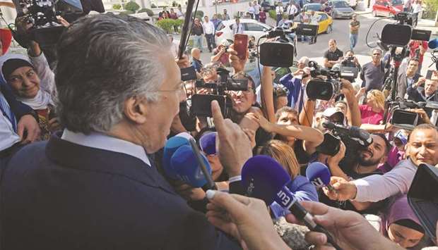 Tunisian presidential candidate Nabil Karoui speaks to journalists in front of his partyu2019s office in Tunis.