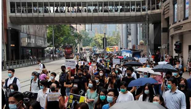 People protest against what they say is the abuse of pro-democracy protesters by Hong Kong police, at Chater Garden in Central district, Hong Kong