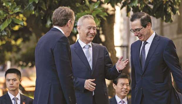 Liu He, Chinau2019s vice premier (centre), talks to Robert Lighthizer, US trade representative (left), and Steven Mnuchin, US Treasury secretary, before a meeting at the Office of the US Trade Representative in Washington, DC, yesterday. As negotiators concluded a second day of trade talks, Beijing and Washington appeared close to announcing an incremental bargain, marking a positive turn after a summer of acrimony and escalation.