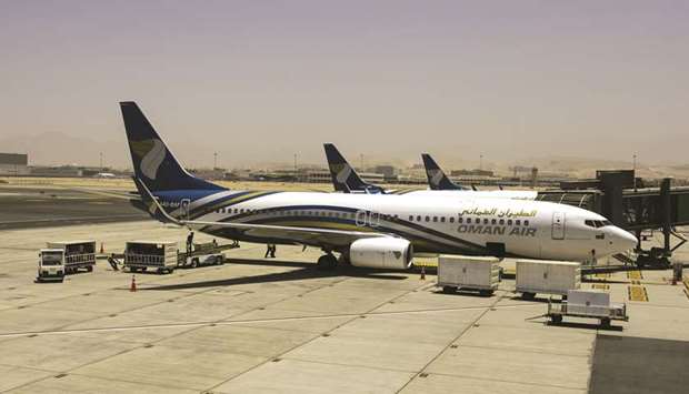 A Boeing 737-800  aircraft, operated by Oman Air, stands beside the passenger terminal at Muscat International  Airport (file). Oman Aviation Group is seeking to raise about $6bn to fund the building of new airports and an  expansion of national airline Oman Air, chief executive officer Mustafa al-Hinai said in April.