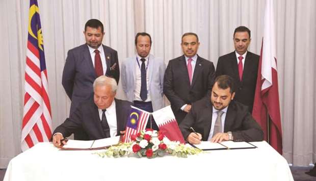 HE al-Kuwari witnessing the signing of an MoU between Baladna Food Industries and FELCRA Bhd, a company owned by the Malaysian  government in Kuala Lumpur recently.