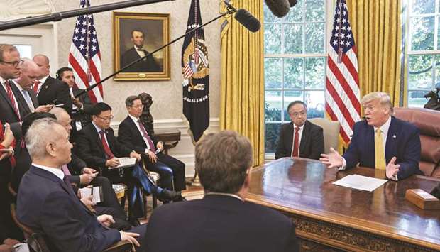 US President Donald Trump speaks during a meeting with Liu He, Chinau2019s vice premier (left), in the Oval Office of the White House in Washington on Friday. Trump said China had pledged to rapidly increase purchases of American farm products to $40bn-$50bn u2013 a stunning feat, and more than double 2017 levels.