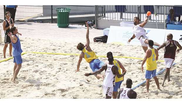 Qataru2019s Kakhi Hani (third from right) in action during the menu2019s Group A beach handball match against Uruguay at Al Gharafa Sports Complex yesterday. PICTURE: Jayan Orma