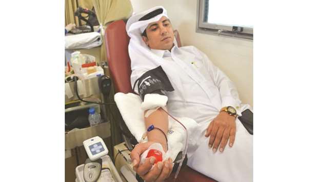 An MoPH staffer donating blood.