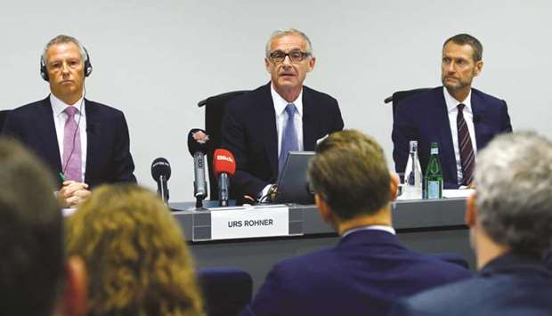Chairman Urs Rohner of Credit Suisse speaks, sitting between John Tiner (left), chairman of the Audit Committee; and Flavio Romerio, managing partner of Homburger and the head of Homburgeru2019s White Collar & Investigations team during a news conference in Zurich yesterday. Credit Suisse chief operating officer Pierre-Olivier Bouee stepped down after ordering detectives to shadow former wealth-management head Iqbal Khan to ensure he didnu2019t poach clients and brokers for his new post at UBS Group AG.