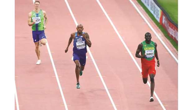 Grenadau2019s Kirani James (right) races to victory in the 400m heat ahead of Vernon Norwood (centre) of the US yesterday. (Reuters)