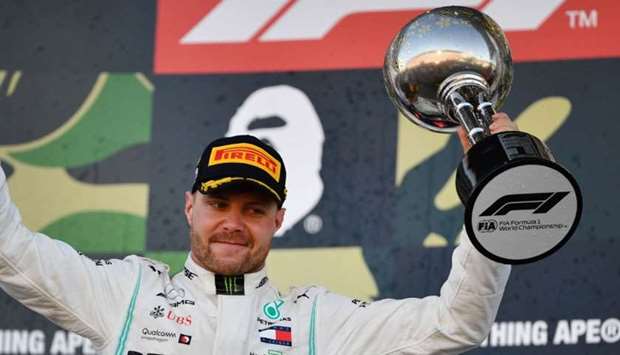 Mercedes' Finnish driver Valtteri Bottas celebrates his victory on the podium after the finish of the Formula One Japanese Grand Prix final at Suzuka