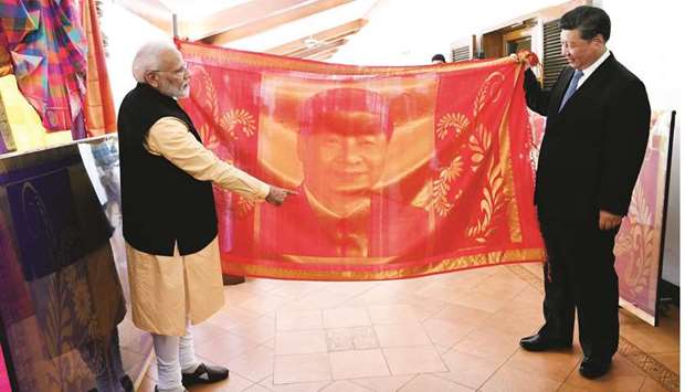 Prime Minister Narendra Modi gifts a silk shawl with an embossed image of Xi Jinping to the Chinese president in Mahabalipuram yesterday.