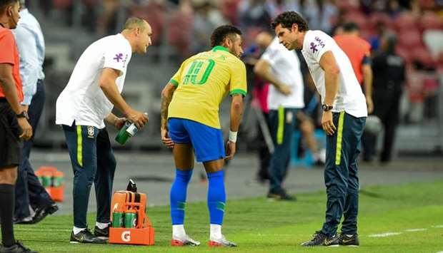 Brazil's forward Neymar (C) leaves the field during an international friendly football match between Brazil and Nigeria at the National Stadium in Singapore