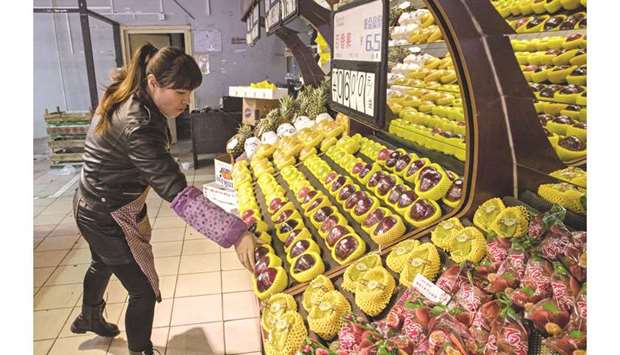 An employee arranges imported American apples for sale at a grocery store in Beijing. US agriculture exports to China totalled $19.5bn in 2017, government data show.