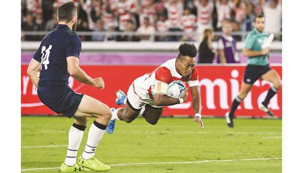 Japanu2019s Kotaro Matsushima (right) scores a try during the Japan 2019 Rugby World Cup Pool A match against Scotland at the International Stadium Yokohama in Yokohama yesterday. (AFP)