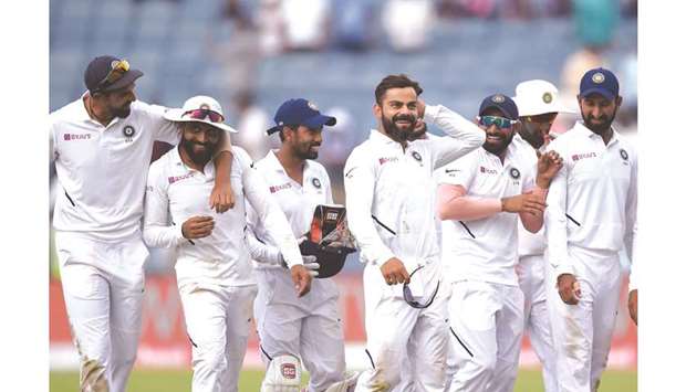 India captain Virat Kohli (fourth from left) celebrates with teammates after winning the second Test against South Africa at the Maharashtra Cricket Association Stadium in Pune yesterday. (AFP)