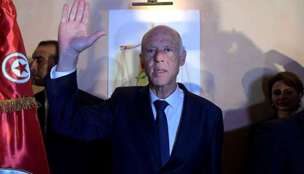 Conservative academic Kais Saied celebrates his victory in the Tunisian presidential election in the capital Tunis.