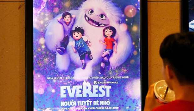 A boy looks at a poster for the animated movie ,Everest Nguoi Tuyet Be Nho,, also known as ,Abominable,, at a movie theatre in Hanoi