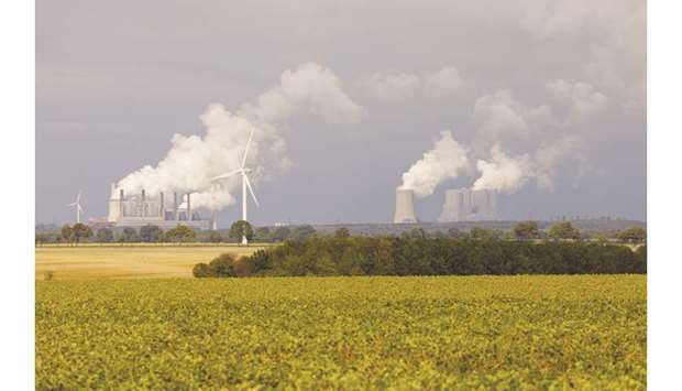 Smoke billows on the horizon from Frimmersdorf, left, and Neurath coal-powered plants, operated by RWE, in Hambach, Germany. Germany has pledged to quit coal-fired power generation by 2038 in order to meet emissions targets under the Paris Agreement on climate change.