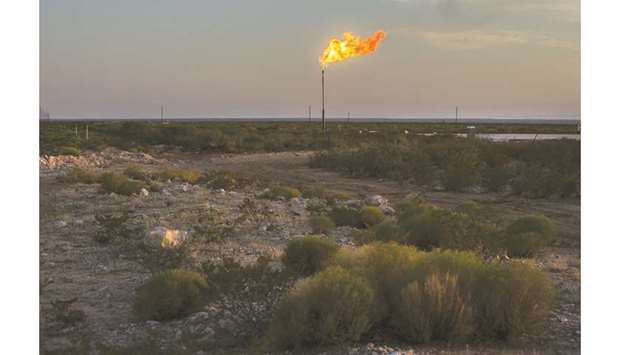A gas flare burns at dusk in the Permian Basin in Texas, US (file). The S&P 500 Oil & Gas Exploration Index has lost 21% in the past 10 years, compared with a 177% rise in the wider market.