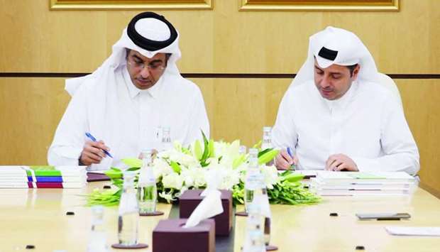 HE the Minister of Education and Higher Education Dr Mohamed Abdul Wahed Ali al-Hammadi and HE the Chairman of the NHRC Dr Ali bin Smaikh al-Marri signing the memorandum.