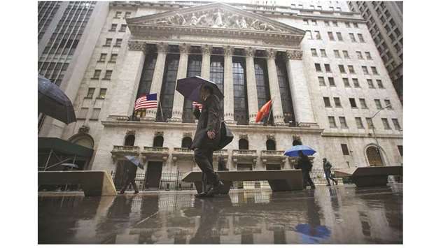 Pedestrians walk past the New York Stock Exchange building (file). The S&P 500 Index rose 1.1% on Friday, closing off its session highs since several of the thorniest trade problems remain unresolved.