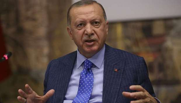 Turkish President Tayyip Erdogan talks to journalists in Istanbul, Turkey