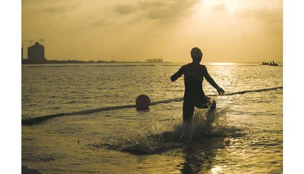 An athlete takes part in Aquathlon event during the ANOC World Beach Games at the Katara Beach yesterday.