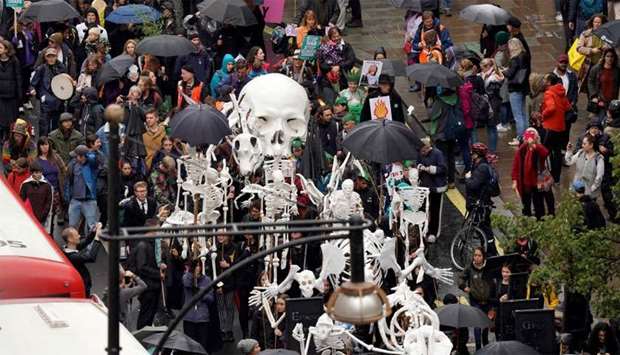 Climate change activists attend an Extinction Rebellion demonstration in London, Britain