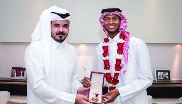 HE the president of Qatar Olympic Committee Sheikh Joaan bin Hamad al-thani honours Qatar's high jump champion Mutaz Barshim at a ceremony in Doha Monday