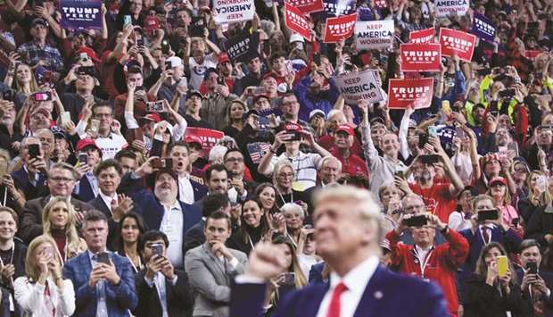 This file photo taken on October 10 shows Trump at a u2018Keep America Greatu2019 rally at the Target Centre in Minneapolis, Minnesota. An Internet meme that depicts him shooting and stabbing media characters and political opponents was shown at a conference for his supporters, the New York Times reported.