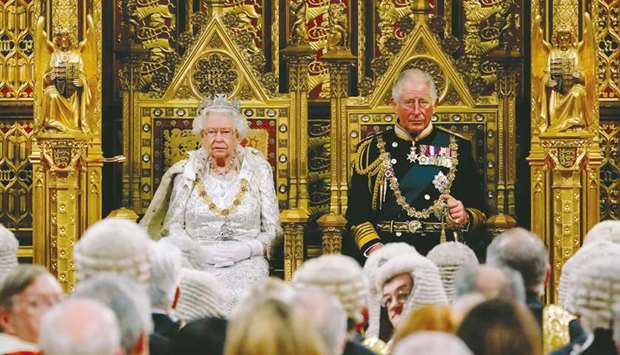 Queen Elizabeth II takes her seat on the The Sovereignu2019s Throne in the House of Lords next to Prince Charles, Prince of Wales, before reading the Queenu2019s Speech during the state opening of Parliament in the Houses of Parliament in London yesterday.