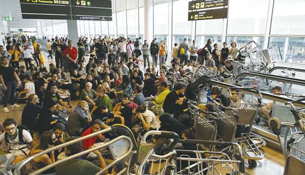 Protesters use trolleys to block escalators at El Prat airport in Barcelona.