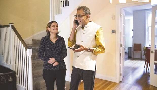 Abhijit Banerjee speaks on the phone as his wife Esther Duflo looks on at their home in Boston, Massachusetts yesterday.