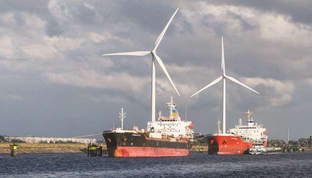 Tankers sit moored near wind turbines at the Port of Rotterdam in Rotterdam, Netherlands (file). A move by the EIB to boost support for renewables would reinforce the Green Deal being pushed by Ursula von der Leyen, the incoming president of the European Commission.