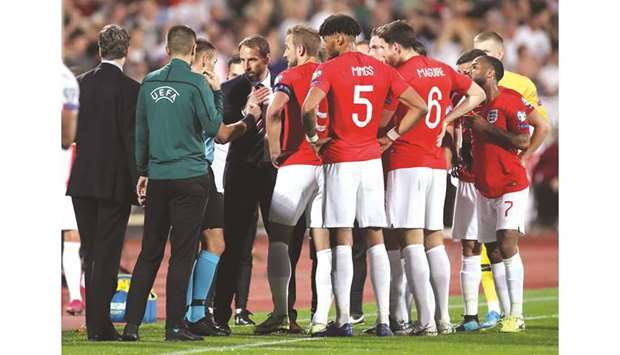 England players and manager Gareth Southgate (centre) speak to referee Ivan Bebek as the match is stopped after racist chants from Bulgarian fans during the Euro 2020 Group A qualifying match at the Vasil Levski National Stadium in Sofia, Bulgaria, on Monday night. (Reuters)