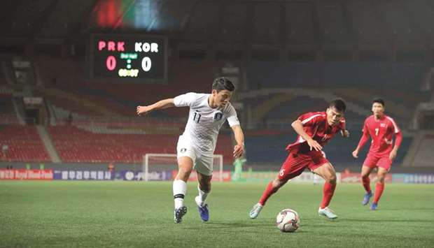 South Koreau2019s Hwang Hee-chan (left) and North Koreau2019s Kim Chol Bom vie for the ball  during the FIFA World Cup 2022 and Asian Cup 2023 qualifying match in Pyongyang. (AFP)