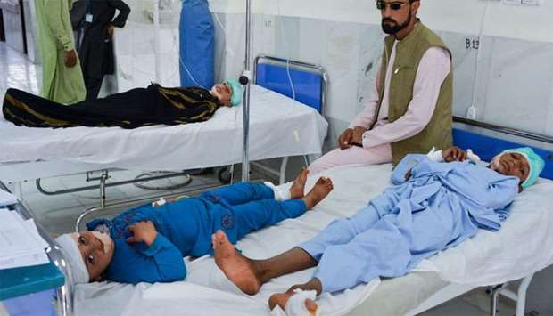 Children receive medical treatment in a hospital after being injured in a bomb blast in Alishang, Laghman province