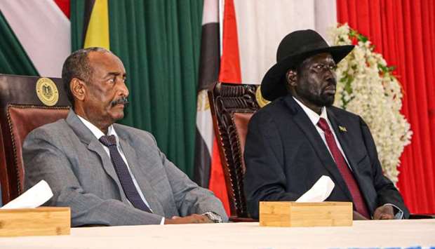 President of Sudanese Transitional Council General Abdel Fattah al-Burhan (L) and President of South Sudan Salva Kiir attend a meeting to endorse the peace talks between Sudan's government and rebel leaders in Juba, South Sudan
