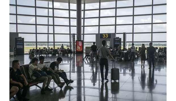Passengers wait at a boarding gate at Changsha Huanghua International Airport in Changsha, Hunan, China. If the global aviation sector were a country, its total contribution (direct, indirect, induced and catalytic) of $2.7tn to the GDP, and the 65.5mn jobs it supports, would be comparable to the UKu2019s economic size and population, notes the Air Transport Action Group.