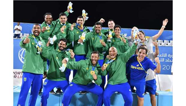 Brazilian menu2019s beach handball team celebrate on the podium after winning gold in the competition at ANOC World Beach Games at Katara Beach yesterday. (Laurel Photo Services)