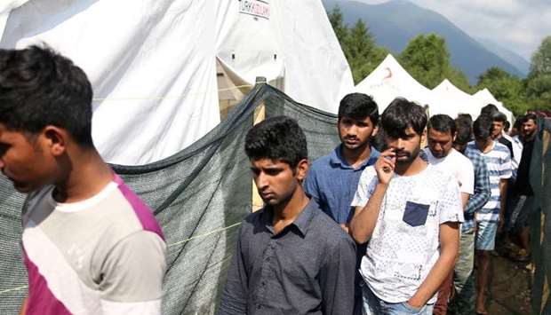 Migrants wait for breakfast in the Vucjak camp in Bihac, Bosnia