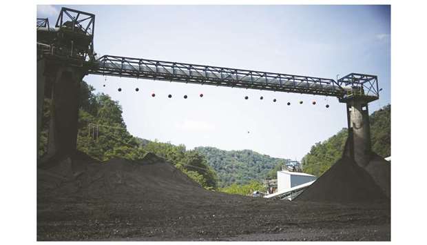 Mounds of coal sit beneath conveyor belts at a coal preparation plant in Logan County near Yolyn, West Virginia, US (file). The clearest sign yet that Americau2019s Coal County is headed for widespread job cuts: The amount of coal being produced per US miner is at the lowest level in eight years.