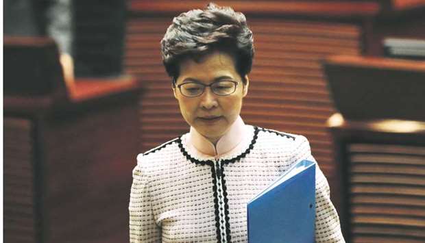 Hong Kong Chief Executive Carrie Lam reacts as lawmakers shout slogans, disrupting her annual policy address at the Legislative Council in Hong Kong yesterday.