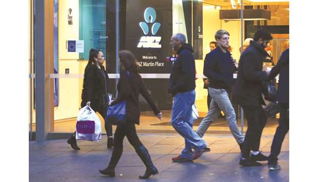 Pedestrians walk past an Australia and New Zealand Banking Group Ltd (ANZ Bank) branch in Sydney. The bank has agreed to reduce the sale price of its OnePath  pensions and wealth business to IOOF Ltd as the nationu2019s largest banks exit an industry thatu2019s been plagued by misconduct.