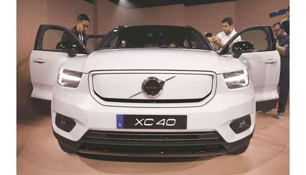 Members of the media view the Volvo XC40 electric SUV during an unveiling event in Los Angeles on Wednesday. Volvo is tying the launch of its first  all-electric vehicle to a broader plan for shrinking the carbon footprint of its models by 40% through 2025.