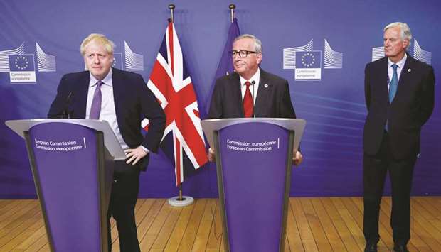 Prime Minister Boris Johnson, European Commission president Jean-Claude Juncker and European Unionu2019s chief Brexit negotiator Michel Barnier attend a news conference after agreeing on the Brexit deal, at the sidelines of the European Union leaders summit, in Brussels, Belgium, yesterday.